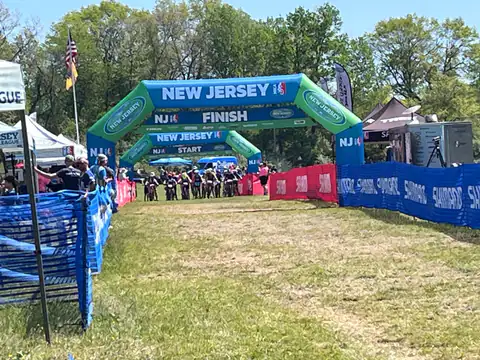The New Jersey league finish arch, with riders lined up at the start in the distance.